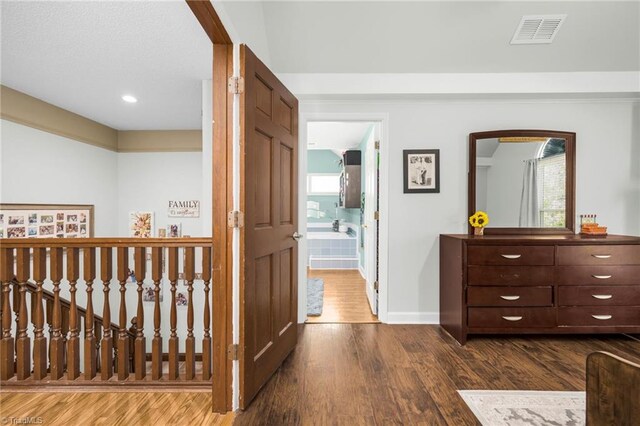 1705 Braemore Ct, Kernersville, NC 27284 - corridor featuring arched walkways, baseboards, dark wood-style floors, and visible vents