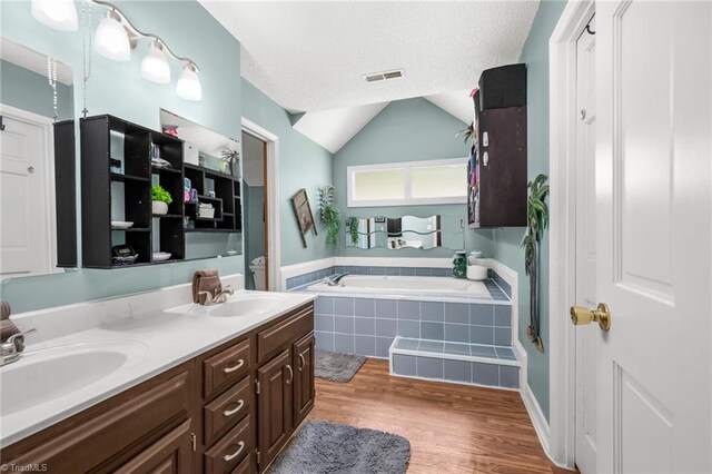 1705 Braemore Ct, Kernersville, NC 27284 - bathroom featuring a sink, double vanity, wood finished floors, visible vents, and a bath