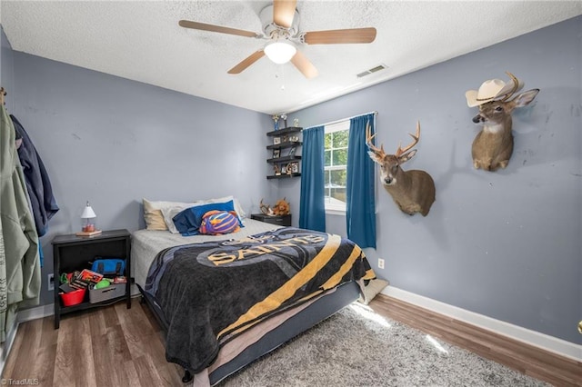 1705 Braemore Ct, Kernersville, NC 27284 - bedroom featuring ceiling fan, a textured ceiling, visible vents, and wood finished floors