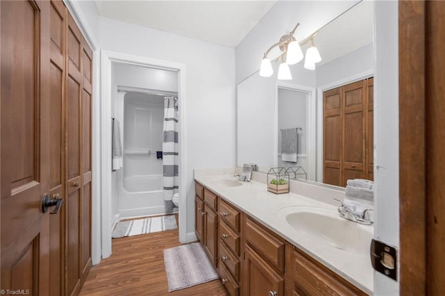 1705 Braemore Ct, Kernersville, NC 27284 - bathroom featuring double vanity, a sink, wood finished floors, and toilet