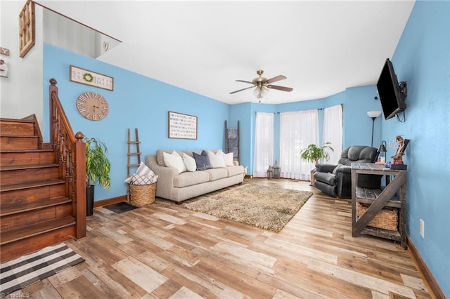 1705 Braemore Ct, Kernersville, NC 27284 - living area with baseboards, light wood finished floors, ceiling fan, and stairway
