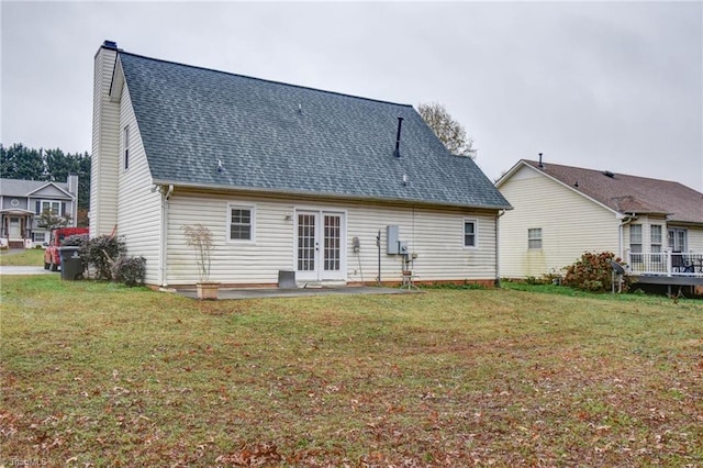 back of house featuring french doors, a patio area, and a lawn