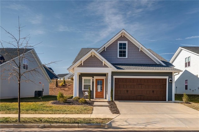 view of front facade with a garage and central AC unit