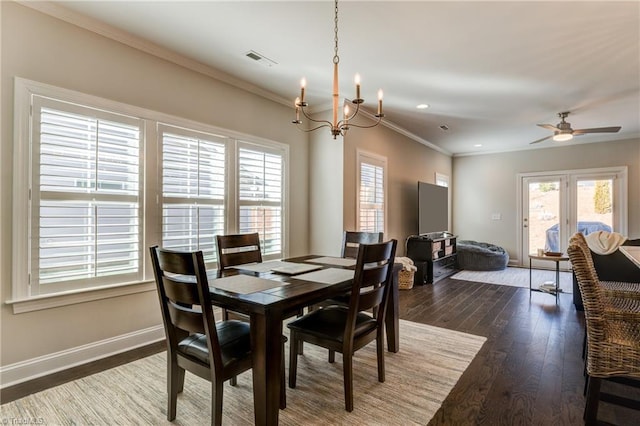 dining area featuring dark hardwood / wood-style flooring, ceiling fan with notable chandelier, and ornamental molding