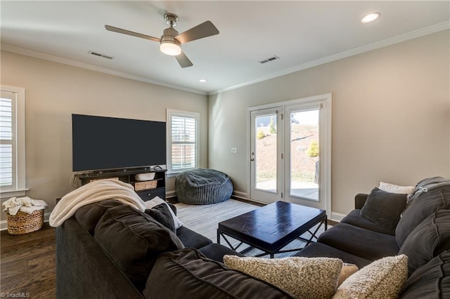 living room with crown molding, ceiling fan, and dark hardwood / wood-style flooring