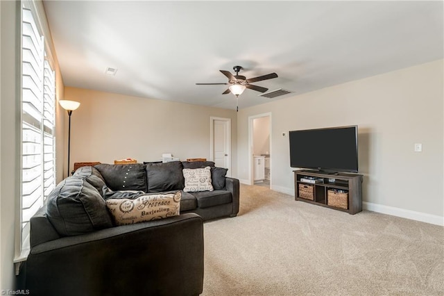 living room featuring carpet floors and ceiling fan