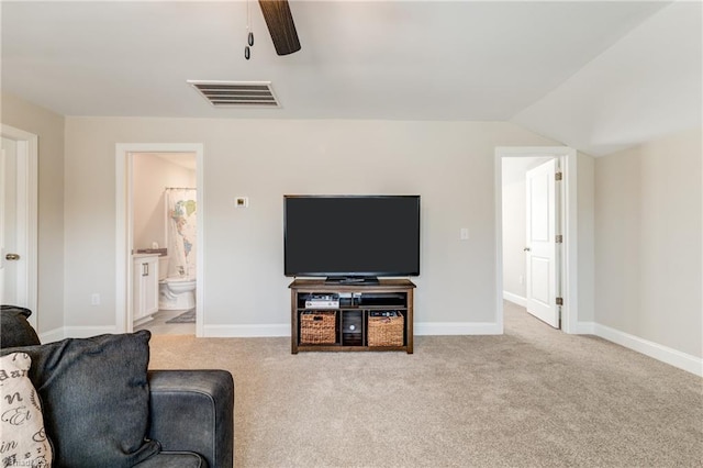 carpeted living room featuring ceiling fan and lofted ceiling