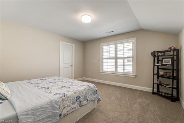 bedroom with carpet floors and vaulted ceiling