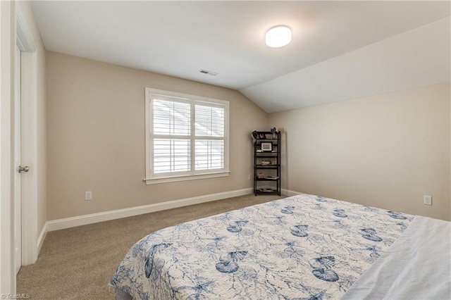 carpeted bedroom featuring vaulted ceiling