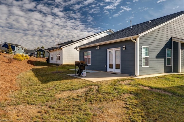 back of house with a lawn and a patio area