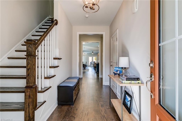 entrance foyer with a notable chandelier and dark wood-type flooring