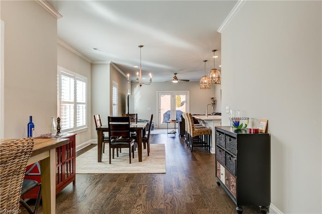 dining area with an inviting chandelier, crown molding, and dark wood-type flooring