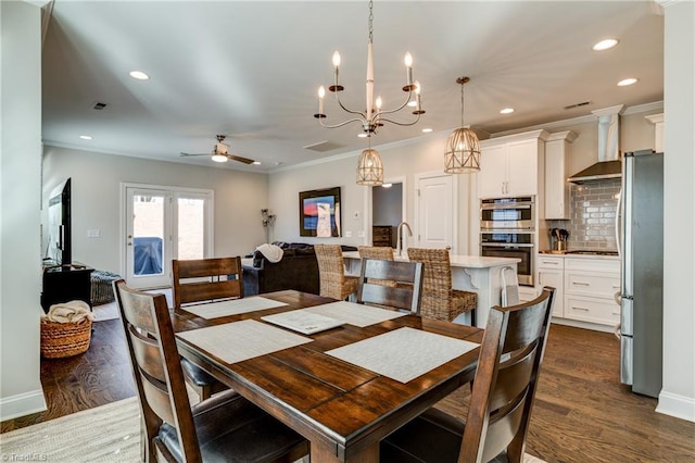 dining room with crown molding, sink, ceiling fan, and dark hardwood / wood-style flooring