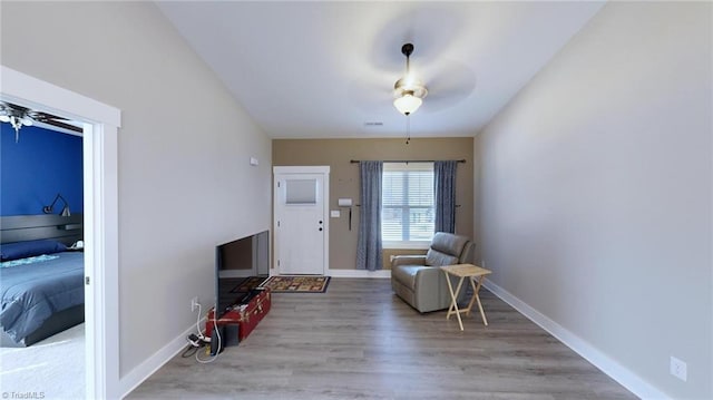 unfurnished room featuring light wood-type flooring and ceiling fan