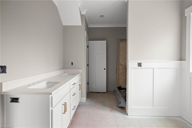 bathroom featuring ornamental molding and vanity