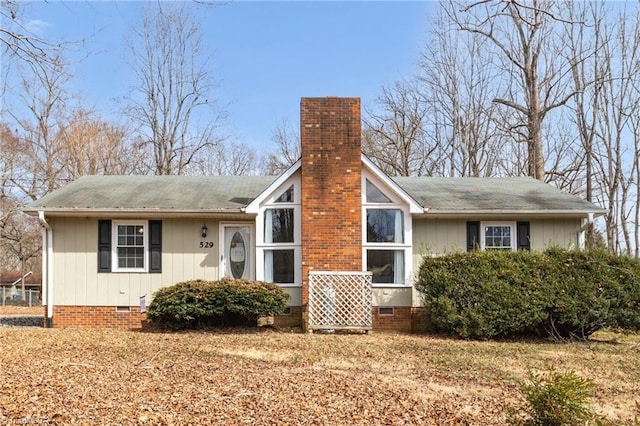 exterior space with crawl space and a chimney