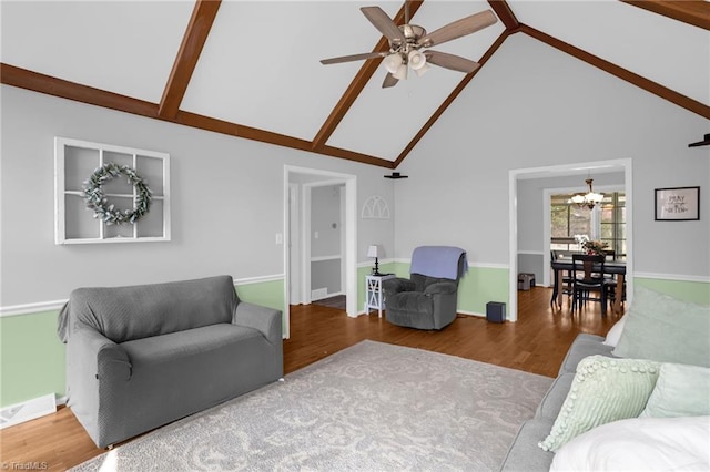 living room with baseboards, visible vents, wood finished floors, high vaulted ceiling, and ceiling fan with notable chandelier