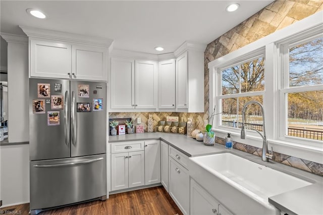 kitchen featuring white cabinets, stainless steel fridge, dark hardwood / wood-style flooring, and sink