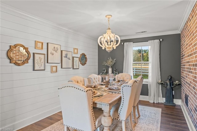 dining area with an inviting chandelier, dark hardwood / wood-style floors, and ornamental molding