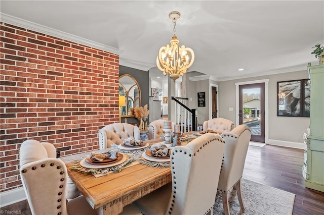 dining space with a chandelier, ornamental molding, dark wood-type flooring, and brick wall