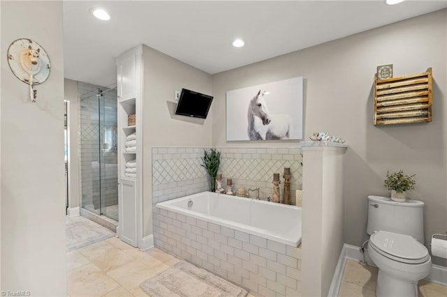 bathroom featuring shower with separate bathtub and toilet