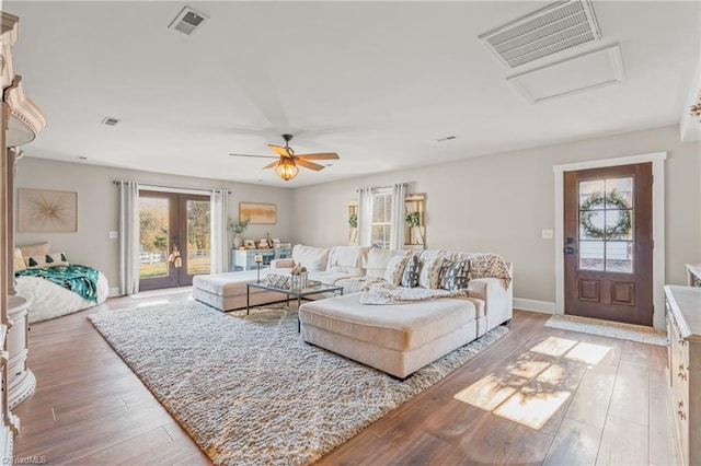 living room featuring ceiling fan, french doors, and hardwood / wood-style flooring