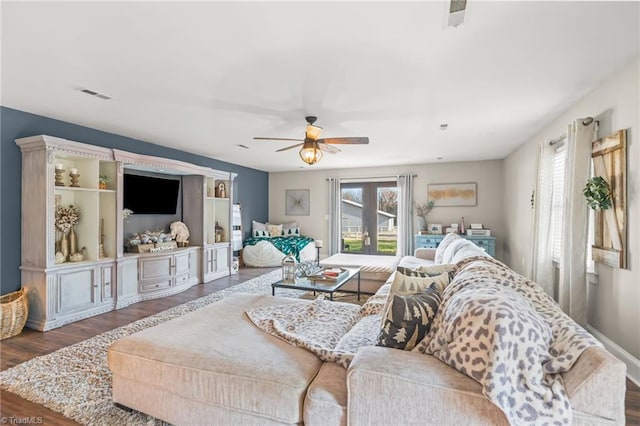 living room featuring french doors, ceiling fan, and dark wood-type flooring