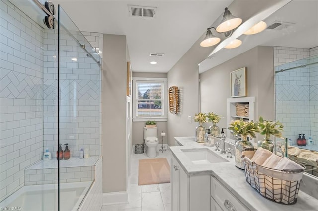 full bathroom featuring vanity, toilet, and shower / bath combination with glass door