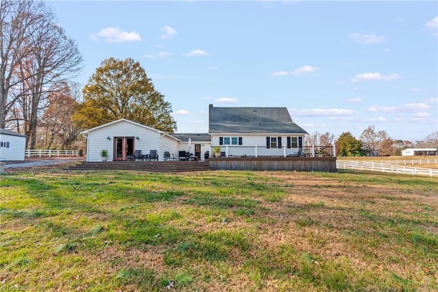 back of house with a lawn and a deck