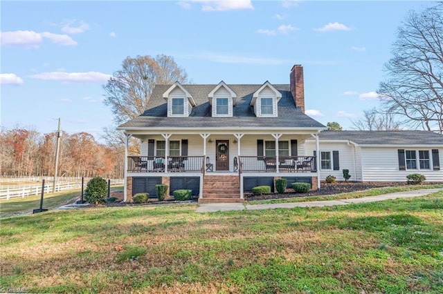 new england style home with a porch and a front yard