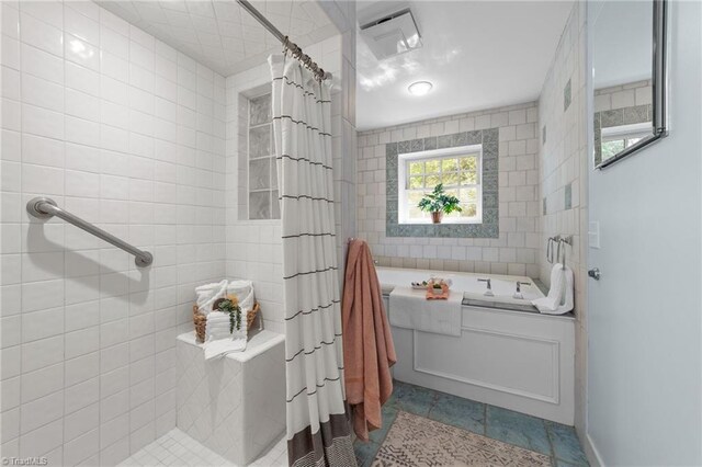 full bathroom with tile patterned flooring, visible vents, tile walls, tiled shower, and a bath