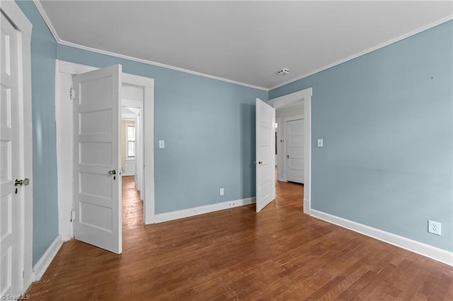 unfurnished bedroom with baseboards, ornamental molding, and wood finished floors