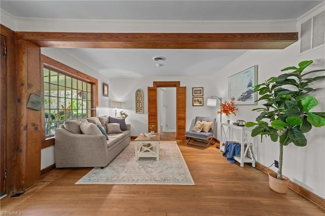 living area with light wood-style floors, baseboards, and visible vents