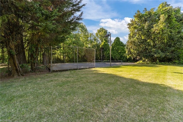 surrounding community featuring a yard and a tennis court