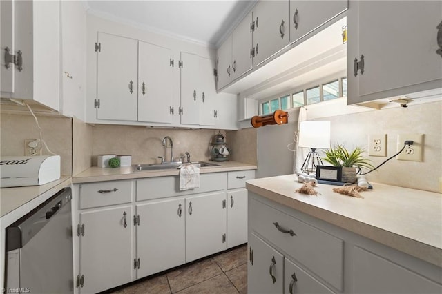 kitchen with a sink, dishwasher, light countertops, tasteful backsplash, and ornamental molding