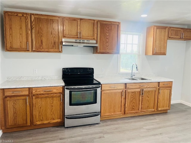 1406 E Pine St, Mount Airy, NC 27030 - kitchen with stainless steel electric stove, a sink, under cabinet range hood, light wood-style flooring, and recessed lighting