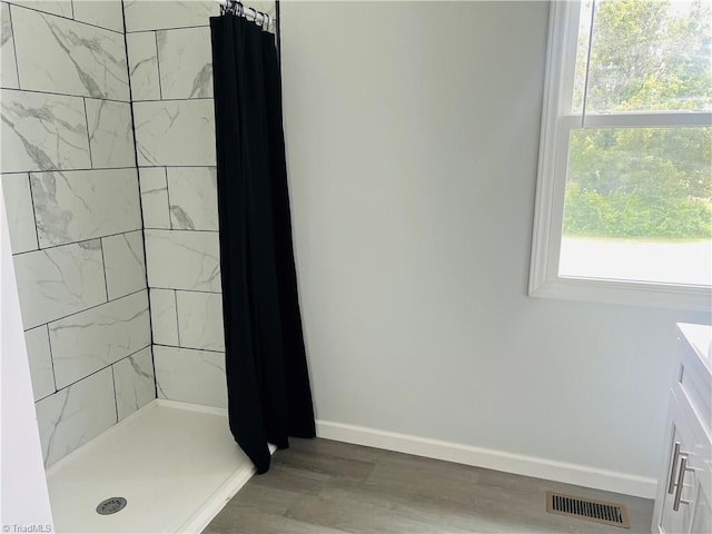 1406 E Pine St, Mount Airy, NC 27030 - bathroom featuring a shower stall, plenty of natural light, wood finished floors, and baseboards