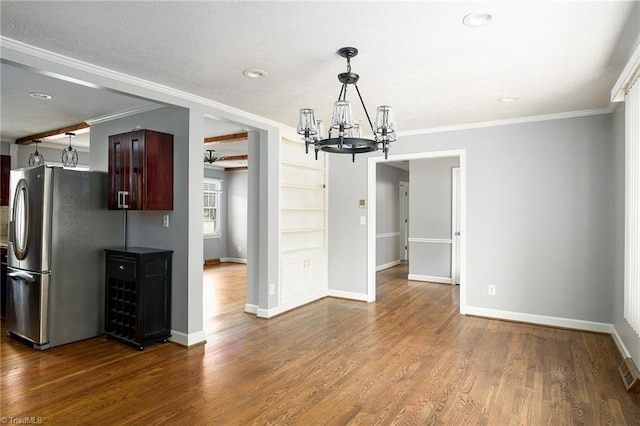 unfurnished dining area with a chandelier, ornamental molding, baseboards, dark wood finished floors, and recessed lighting