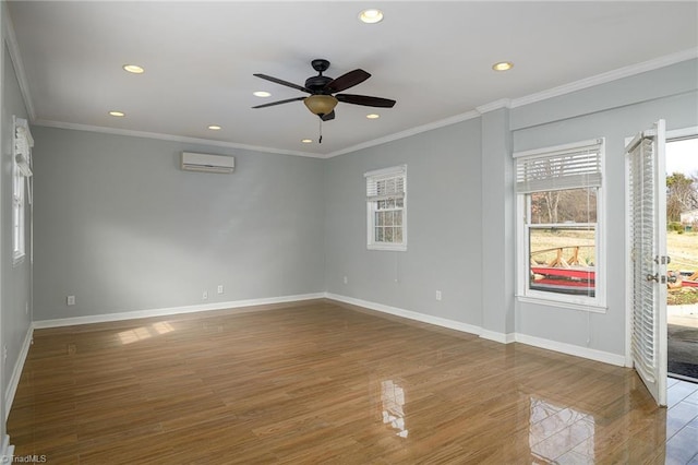 unfurnished room with a wall mounted air conditioner, recessed lighting, wood finished floors, ceiling fan, and baseboards
