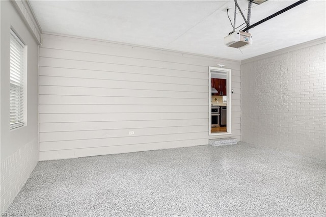 garage with a garage door opener and wood walls