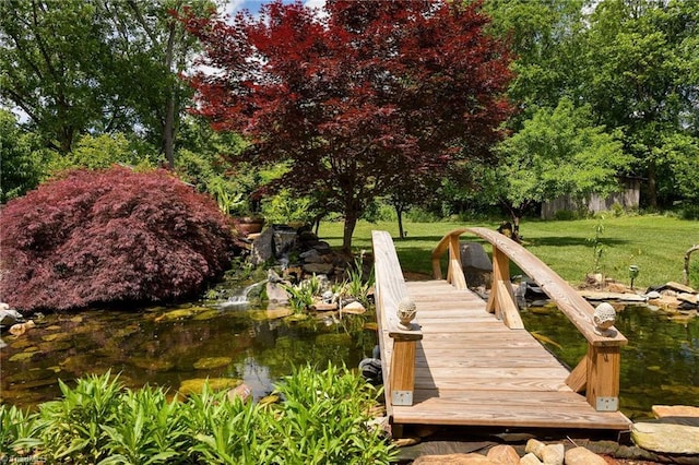 dock featuring a yard and view of scattered trees