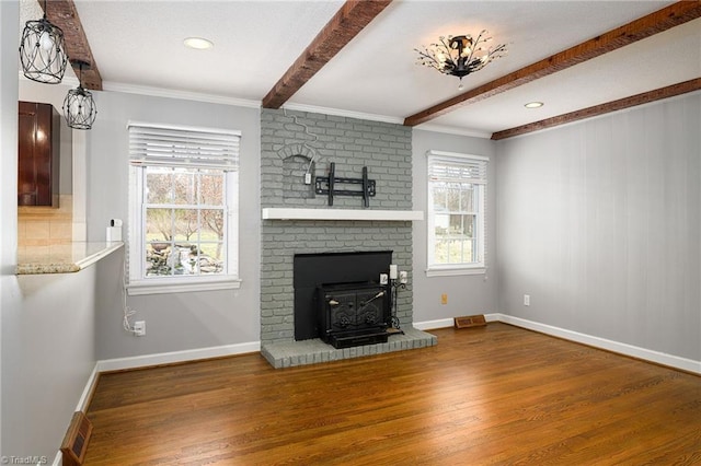 unfurnished living room featuring wood finished floors, beamed ceiling, baseboards, crown molding, and recessed lighting