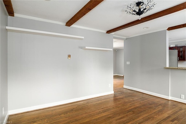 unfurnished room featuring beam ceiling, wood finished floors, baseboards, and ornamental molding