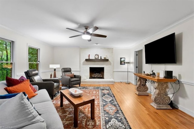 573 Doe Run Dr, Kernersville, NC 27284 - living area featuring wood finished floors, a ceiling fan, crown molding, a fireplace, and baseboards