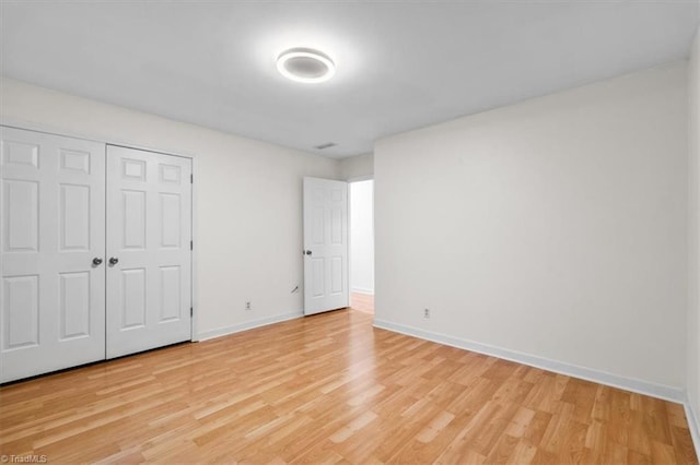 573 Doe Run Dr, Kernersville, NC 27284 - unfurnished bedroom with light wood-style flooring, baseboards, and a closet