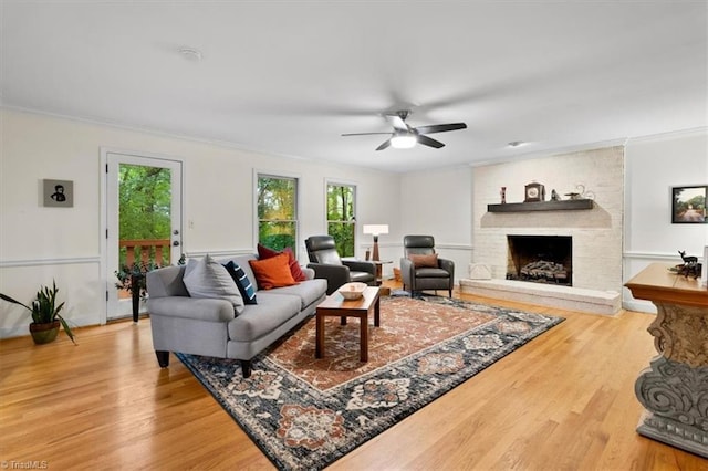 573 Doe Run Dr, Kernersville, NC 27284 - living room with crown molding, a fireplace, wood finished floors, and a ceiling fan