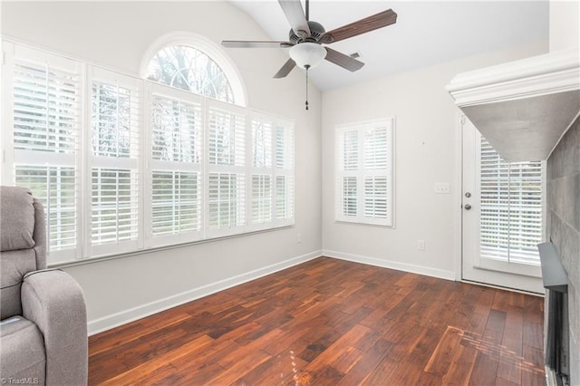 unfurnished room featuring ceiling fan, vaulted ceiling, baseboards, and hardwood / wood-style flooring