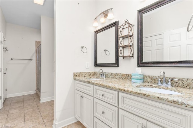 full bath with double vanity, tile patterned flooring, a sink, and a shower stall