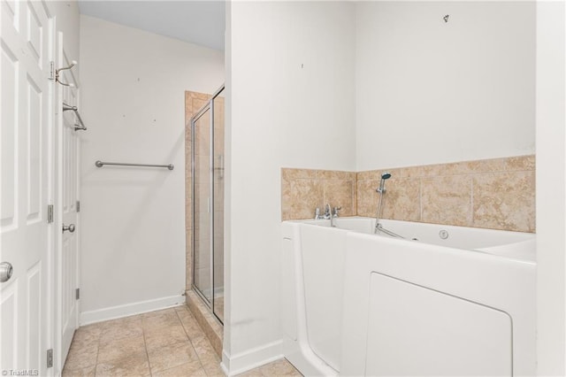 full bath featuring a stall shower, tile patterned flooring, a bath, and baseboards