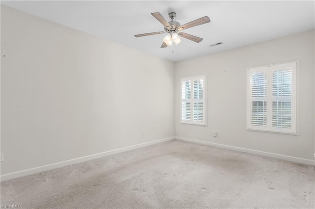 spare room with carpet, plenty of natural light, baseboards, and a ceiling fan